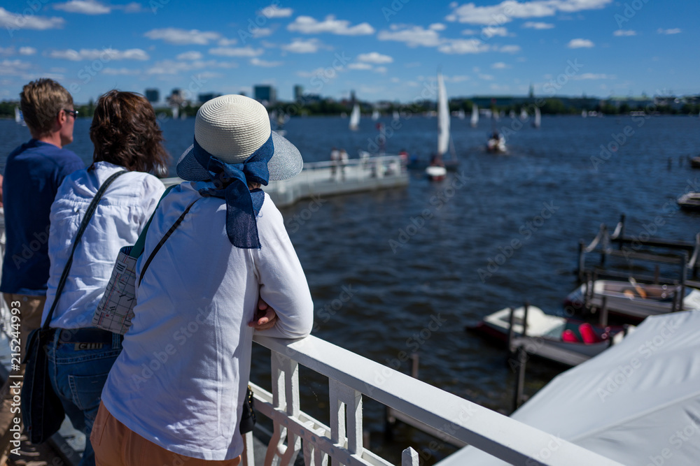 People enjoying the sun at the Alter River in Hamburg