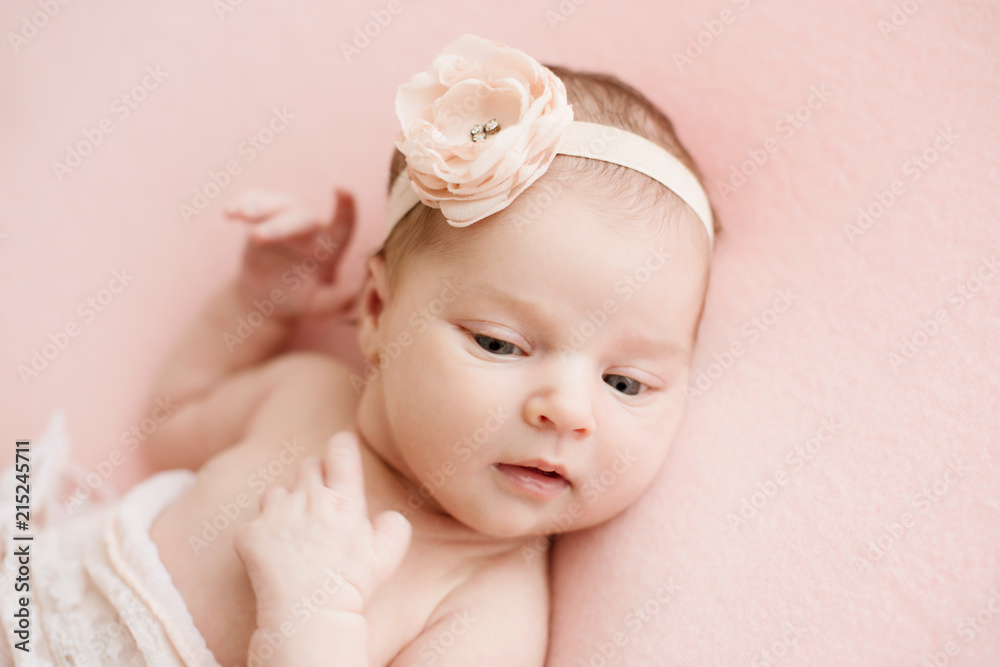Newborn girl on a pink background. Photoshoot for the newborn. 7 days from birth. A portrait of a beautiful, seven day old, newborn baby girl Newborn girl on a pink background. Photoshoot for the newborn. 7 days from birth. A portrait of a beautiful, seven day old, newborn baby girl