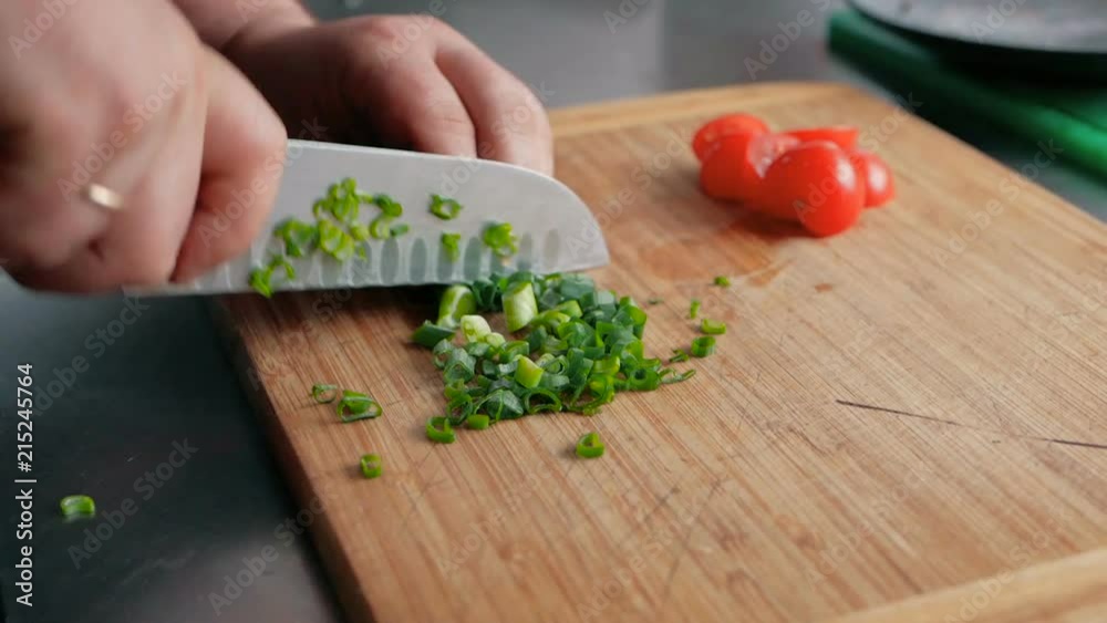 chef to cut an onion on a wooden board in the restaurant kitchen. cooking salad step by step chef to cut an onion on a wooden board in the restaurant kitchen. cooking salad step by step
