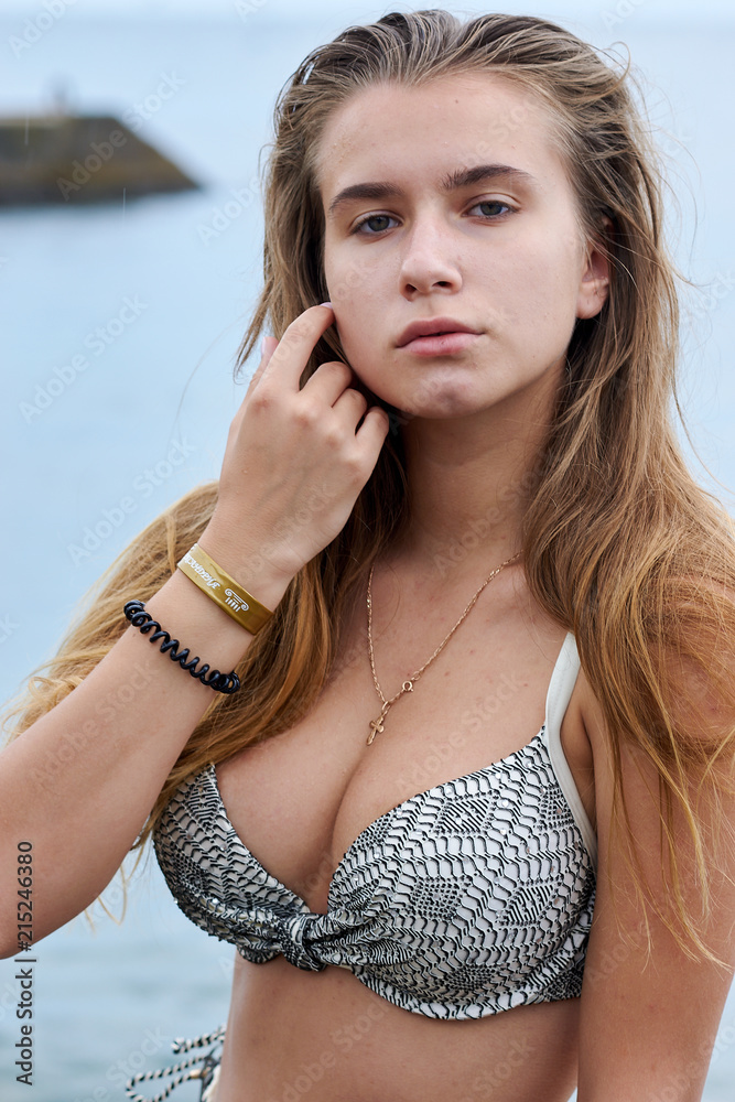 Foto Stock Hot sexy curvy young woman in a swimsuit on the beach in Crimea  | Adobe Stock