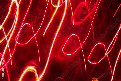 Blurred colorful lights in motion. Inversion. Abstract background in red tones