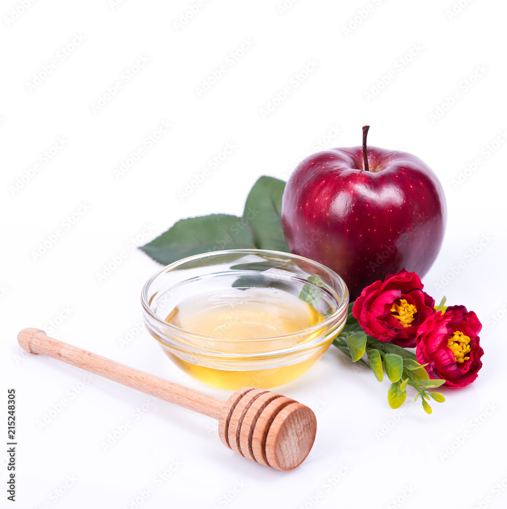 Fototapeta premium Rosh Hashanah Jewish holiday concept - honey, red apple, red flowers and dipper. traditional holiday symbols