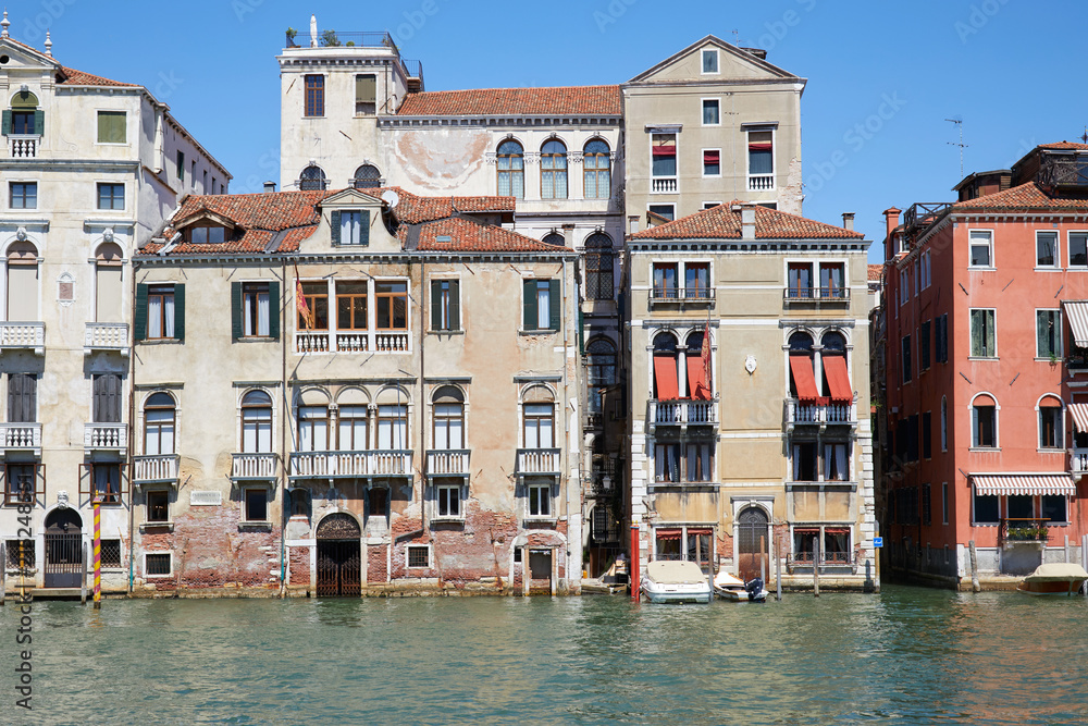 Venice buildings facades and canal in a sunny day in Italy, nobody