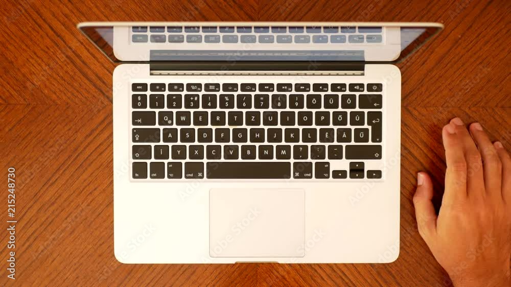 Male hands typing on the laptop keyboard Aerial View