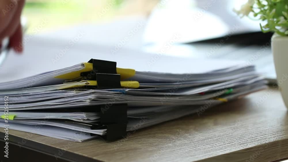 Stacks of papers documents files information business report papers with color clips paper, piles of unfinished achieves with laptop computer desk in modern office, Accounting planning budget concept