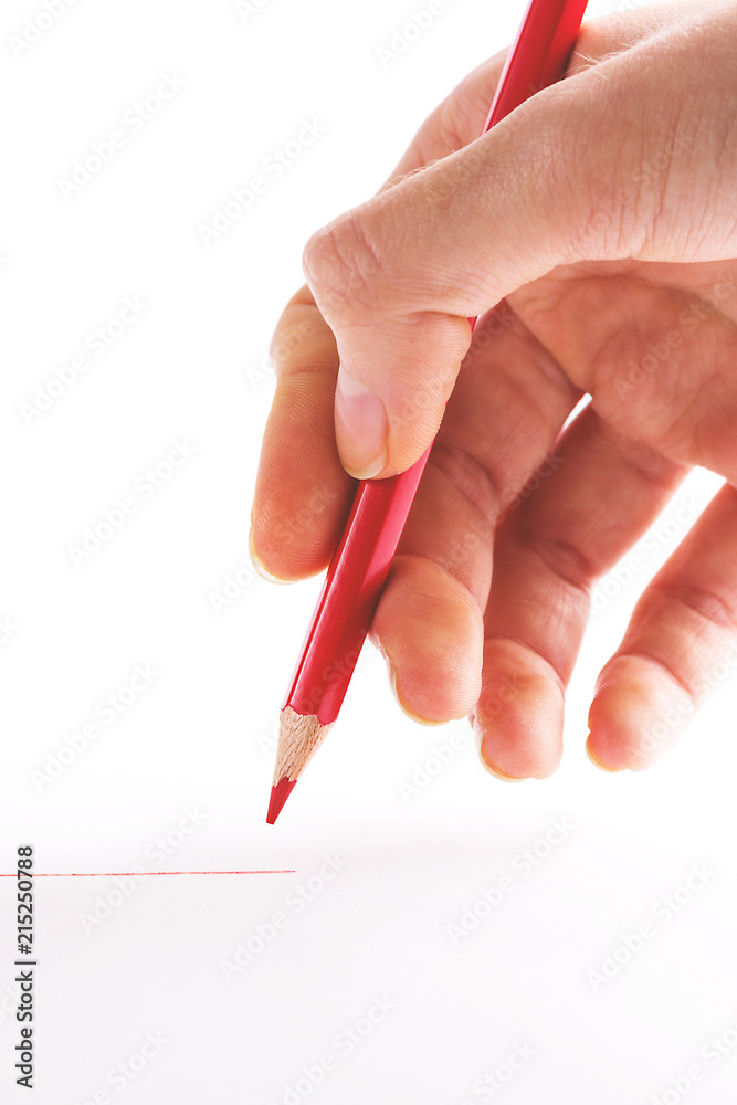 hand with the red pencil on a white background hand with the red pencil on a white background