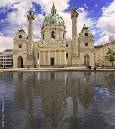 Karlskirche St. Charles’ Church with reflections into the water in Vienna, Austria