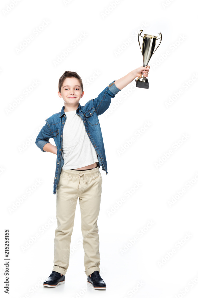 cheerful schoolboy showing winner cup isolated on white cheerful schoolboy showing winner cup isolated on white