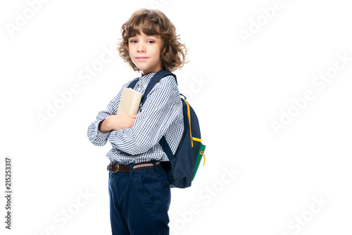 schoolboy hugging book and looking at camera isolated on white
