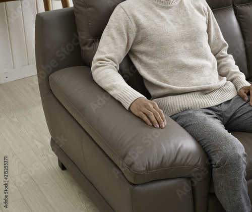hands on a leather cushion on the sofa