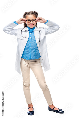 schoolchild in costume of doctor posing isolated on white