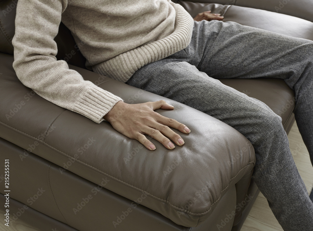 hands on a leather cushion on the sofa hands on a leather cushion on the sofa