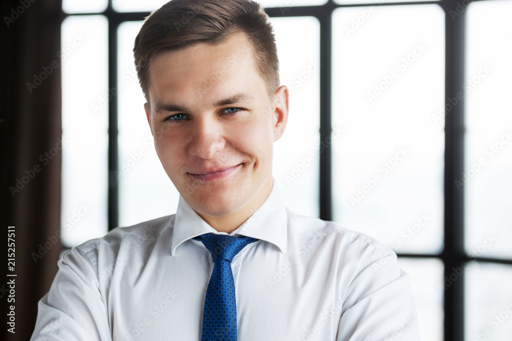 Portrait of confident young business man looking at camera. Portrait of confident young business man looking at camera.