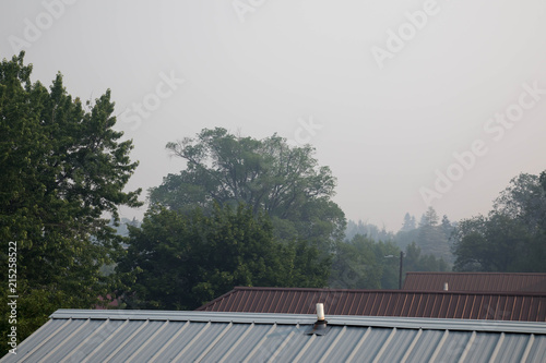 Dense smoke from the 416 fire over metal rooftops in downtown Durango, Colorado
