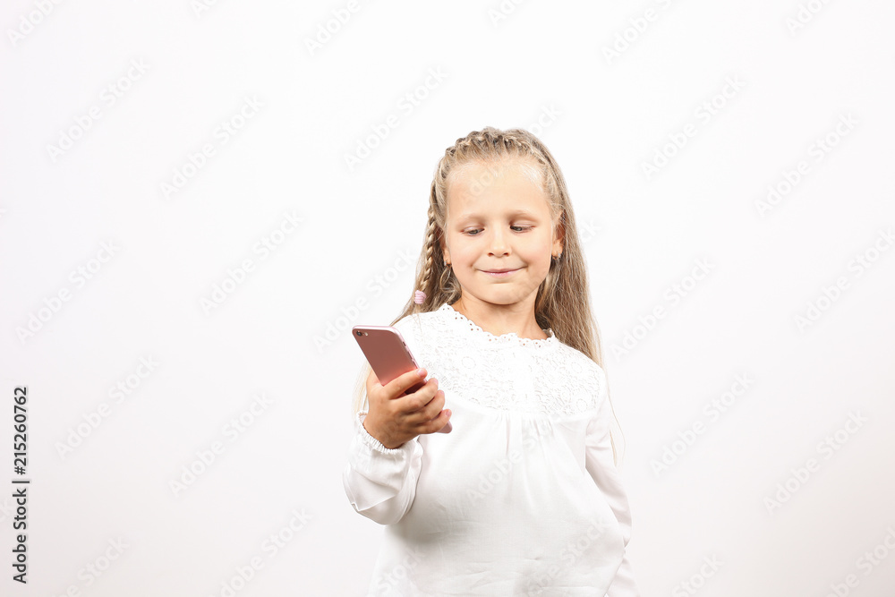 Portrait of positive & funny four year old blonde little girl, holding mobile cell phone, smiling at camera, taking selfies. Childhood & technology concept. Isolated background, copy space, close up. Portrait of positive & funny four year old blonde little girl, holding mobile cell phone, smiling at camera, taking selfies. Childhood & technology concept. Isolated background, copy space, close up.
