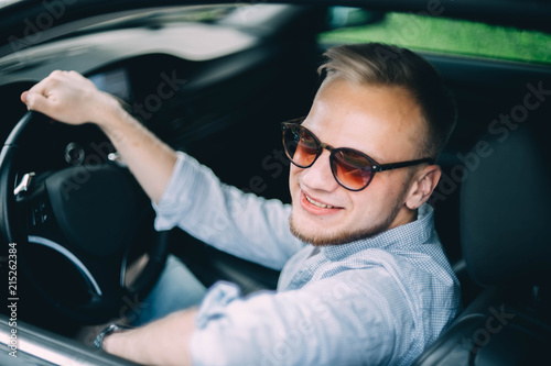 blonde male business car driver in sunglasses. © velimir