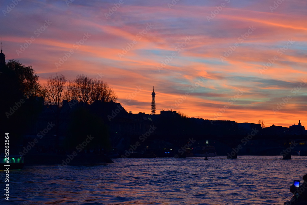 Sunset on the Seine River in Paris with the Eiffel Tower in silhouette Sunset on the Seine River in Paris with the Eiffel Tower in silhouette