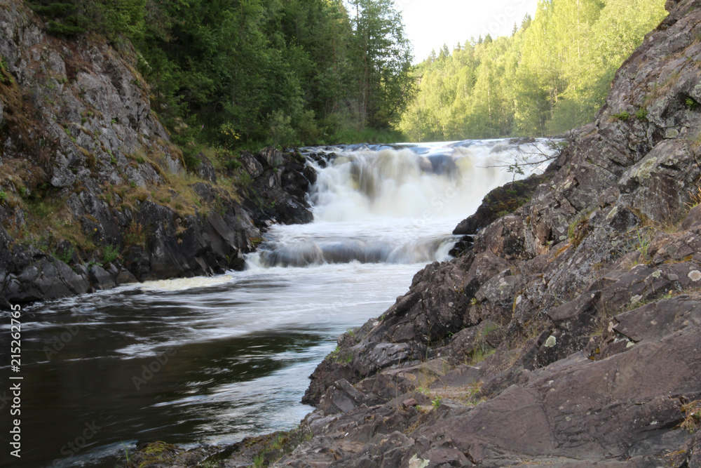Fototapeta premium Mountain waterfall and rocks in the wild