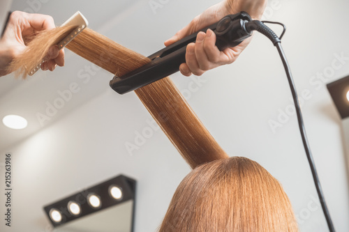 Hairdresser making a hairstyle for client