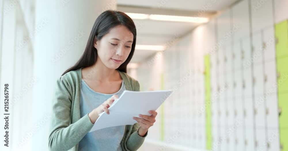Woman reading on note at school