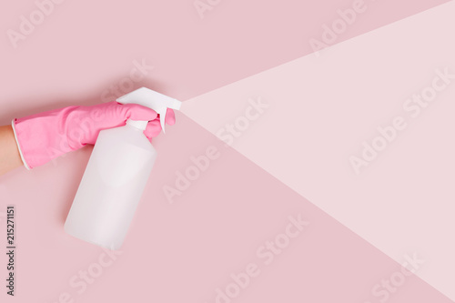 Female hands cleaning on pale pink background. Cleaning or housekeeping concept background. Copy space. Flat lay, Top view.