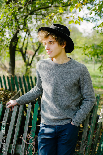 Man leaning on fence