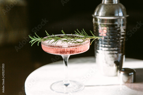 Pink coloured cocktail on a sunlit marble table