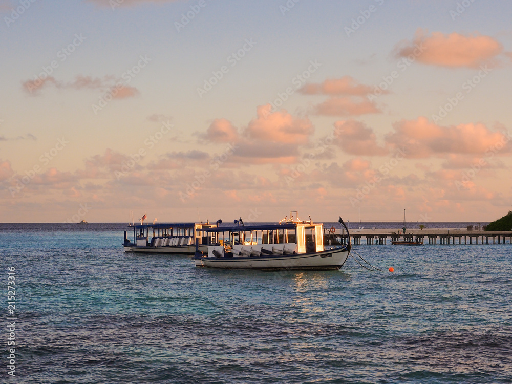 Wooden maldivian boat or Dhoni in blue sea with cloud and sky background for transportation in Maldives concept.