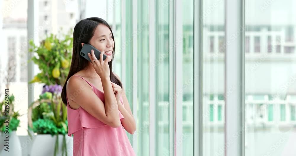 Woman talk to cellphone inside shopping center Woman talk to cellphone inside shopping center