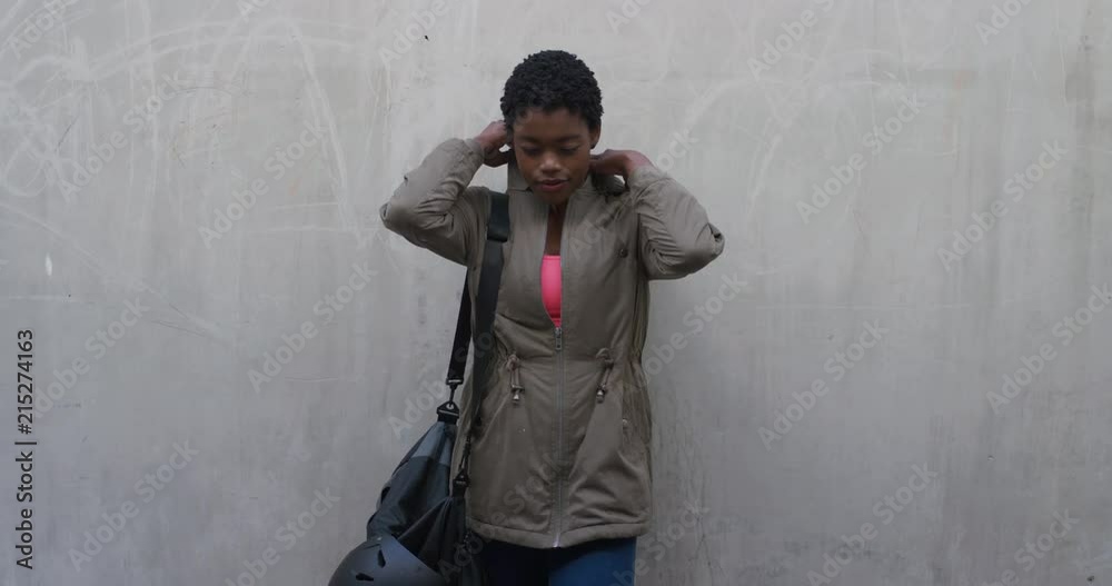 portrait attractive young african american woman looking confident wearing hood sporty independent black female on concrete wall background