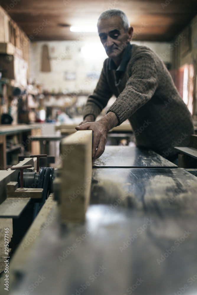 Close up shot of old master carpenter working in his woodwork or workshop