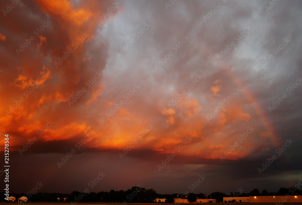 Naklejka premium Super Sunset over an Airfield with a Rainbow in front of a Storm. The State of Michigan, Grand Haven