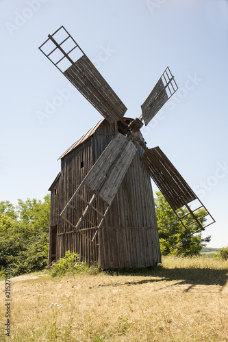 lonely old wooden mill. Summer day. Forest. photo