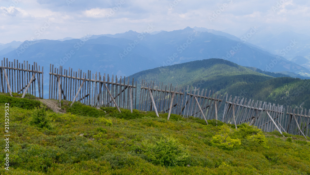 wooden lavine ski protection wall on austrian mountain alps