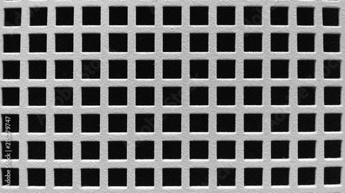 A white grate over a black background background texture.