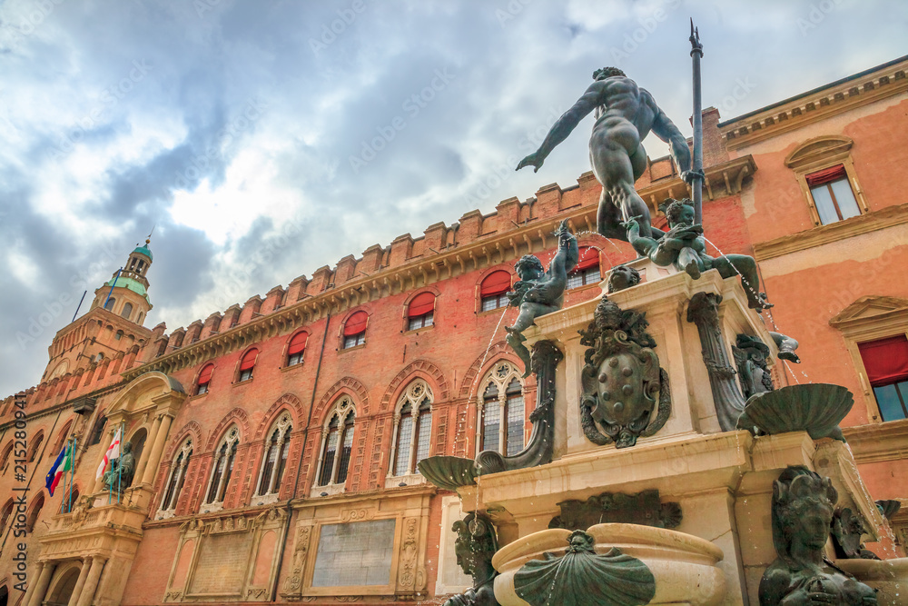 Nettuno 1567 bronze statue and fountain in front of Accursio palace, built in 1290, in Piazza Maggiore square, the seat of the municipal government of Bologna city in Emilia region of Italy.
