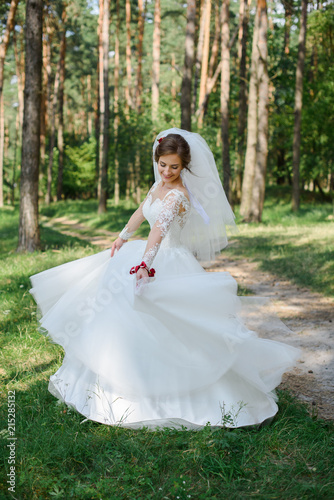 Beautiful bride in wedding dress. Happy newlywed woman. Bride with wedding makeup and hairstyle. Smiling bride. Wedding day. Gorgeous bride. Marriage.