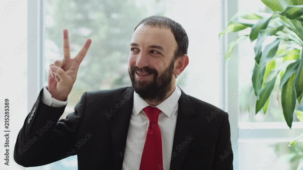 Young Attractive Man showing sign of Victory Young Attractive Man showing sign of Victory