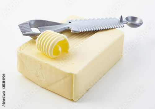 Cutting a curl off a pat of fresh butter