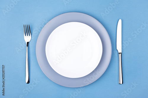 Empty plate with fork and knife. Setting table  top view.