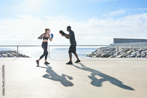 Sportive people fighting on beach