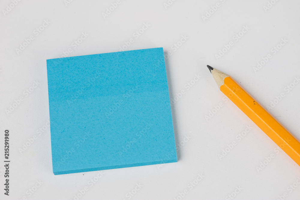 Pencil and sticky notes on a white table. Office accessories for saving notes. Pencil and sticky notes on a white table. Office accessories for saving notes.