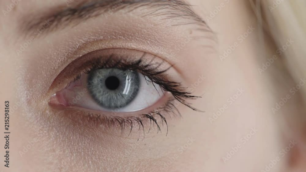 close up beautiful blue eye opening looking at camera iris reflection natural human beauty close up beautiful blue eye opening looking at camera iris reflection natural human beauty