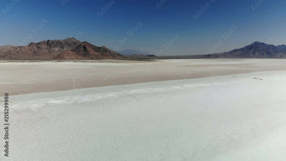 Bonneville Salt Flats in Utah near the Utah-Nevada border. Drone flying low over the salt flats.
Bonneville Salt Flats in Utah near the Utah-Nevada border. Drone flying low over the salt flats.