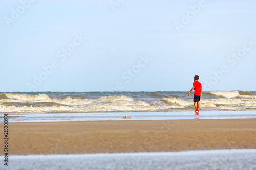 Blur boy on beach.