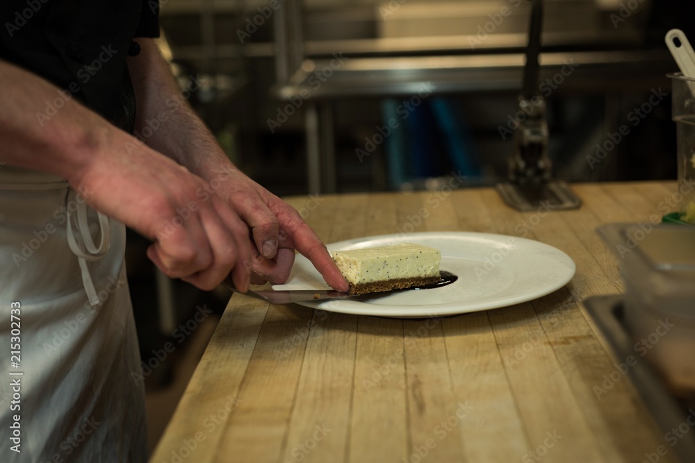 Male chef serving dessert in a plate Male chef serving dessert in a plate