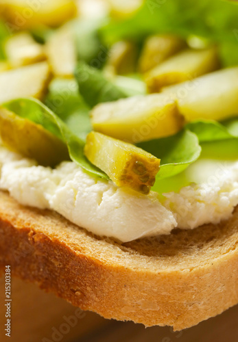 

Cream cheese, pickles and rucolla sandwich, close up