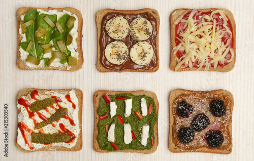 Top view of six open sandwiches on the table