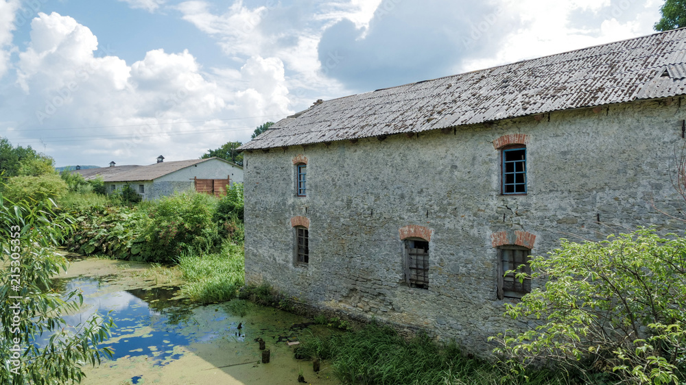Fototapeta premium Old mill, on the bank of the river