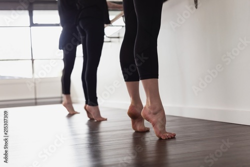 Group of women standing on tip toe on wooden floor